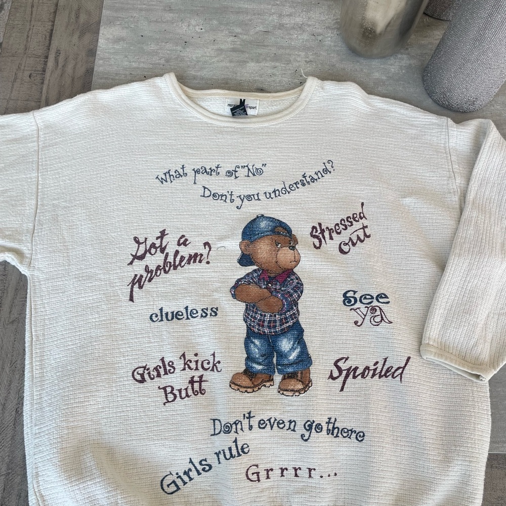 Cream Sweatshirt with Colorful Graphic Design and Blue Accents